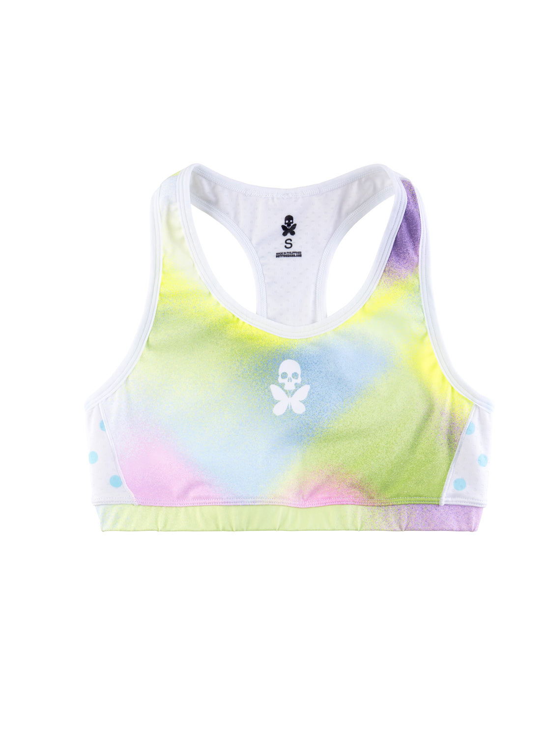 A women's racerback sports bra with a pastel tie-dye pattern in yellow, green, pink, and blue, featuring a white scoop neck, white side panels, and a white skull-and-crossbones logo on the center chest.